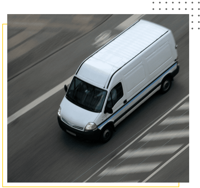 A van driving down the street on a city street.